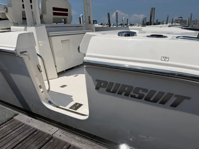Slide: The Image of The 2025 Pursuit S 328 Sport is docked, featuring an open cockpit and sleek details. - 7