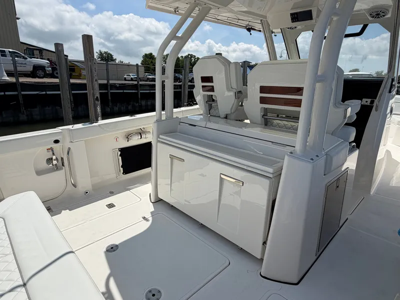Slide: The Image of The image shows the cockpit of a 2025 Pursuit S 328 Sport boat with white seating and storage. - 11