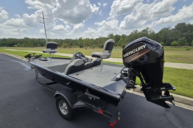 Slide: The Image of 2017 Tracker Pro Team 175 TXW boat with Mercury engine on a trailer, parked outdoors. - 5