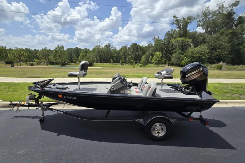 Slide: The Image of 2017 Tracker Pro Team 175 TXW fishing boat on trailer, parked outdoors under a cloudy sky. - 8
