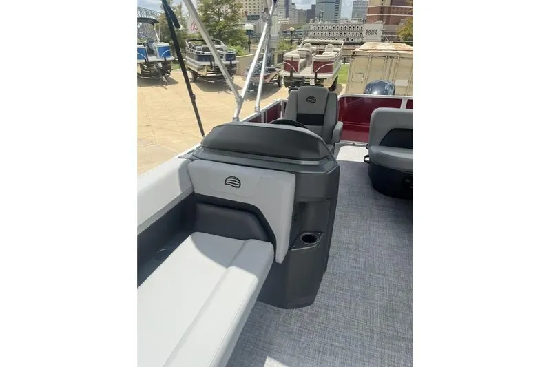 Slide: The Image of 2026 SUNTRACKER pb18 pontoon boat interior with gray seating and modern design. - 11