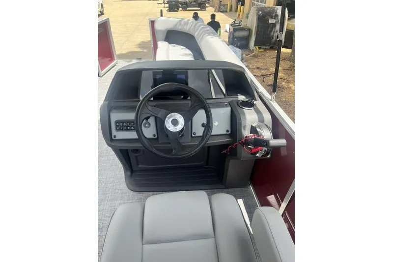 Slide: The Image of 2026 SUNTRACKER pb18 boat dashboard with steering wheel and controls. - 5
