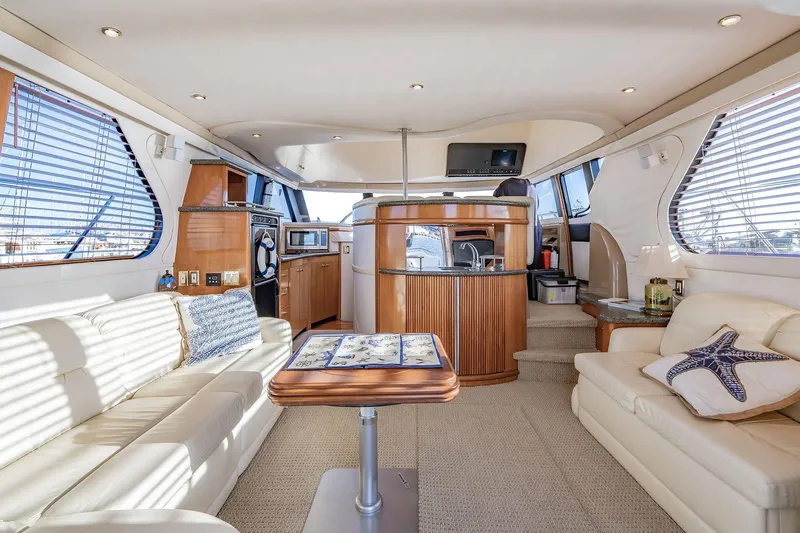Slide: The Image of Luxurious interior of 2000 Carver 450 Voyager Pilothouse yacht with elegant seating and modern amenities. - 32