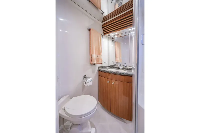 Slide: The Image of Luxurious bathroom in 2000 Carver 450 Voyager Pilothouse with modern fixtures and wood cabinetry. - 65