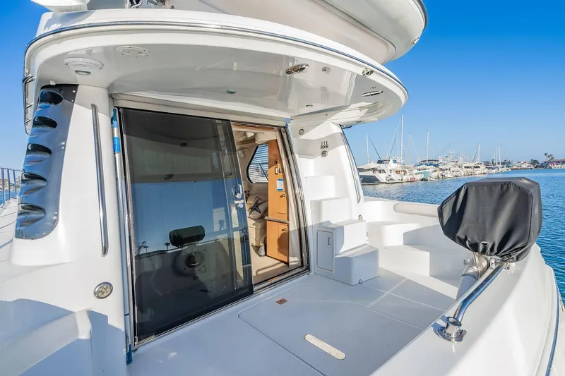 Slide: The Image of 2000 Carver 450 Voyager Pilothouse yacht with open deck and marina view. - 17