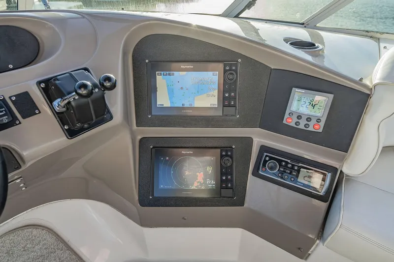 Slide: The Image of Carver 450 Voyager Pilothouse 2000 helm with navigation screens and controls. - 28
