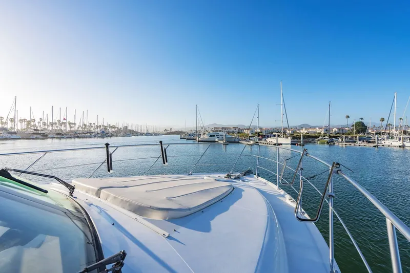 Slide: The Image of Bow view of 2000 Carver 450 Voyager Pilothouse in a marina setting. - 18