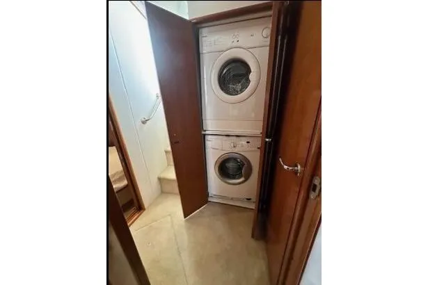 Slide: The Image of Stacked washer and dryer in 2000 Carver 450 Voyager Pilothouse yacht interior. - 52