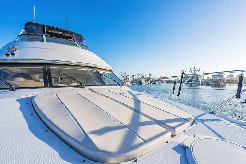 Slide: The Image of 2000 Carver 450 Voyager Pilothouse yacht docked in a sunny marina. - 19