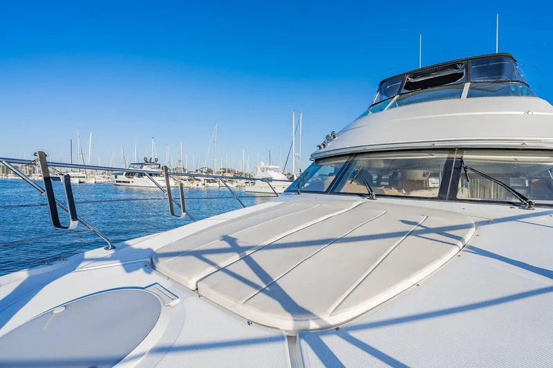 Slide: The Image of 2000 Carver 450 Voyager Pilothouse yacht docked in a marina under clear blue skies. - 21