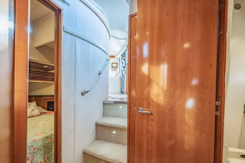 Slide: The Image of Interior view of 2000 Carver 450 Voyager Pilothouse with stairs and wooden door. - 60
