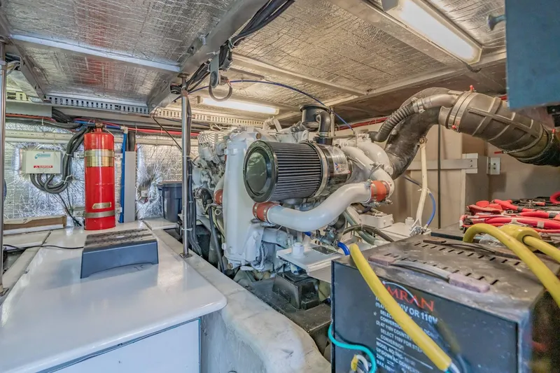 Slide: The Image of Engine room of a 2000 Carver 450 Voyager Pilothouse with visible machinery and equipment. - 72