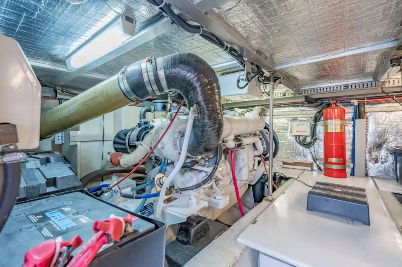 Slide: The Image of Engine room of 2000 Carver 450 Voyager Pilothouse with visible machinery and fire extinguisher. - 71