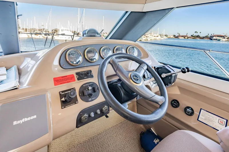 Slide: The Image of Pilothouse interior of 2000 Carver 450 Voyager, featuring steering wheel and control panel. - 44