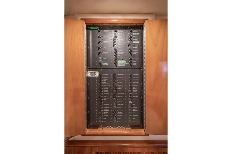 Slide: The Image of Electrical panel inside a 2000 Carver 450 Voyager Pilothouse yacht, showcasing circuit controls. - 67