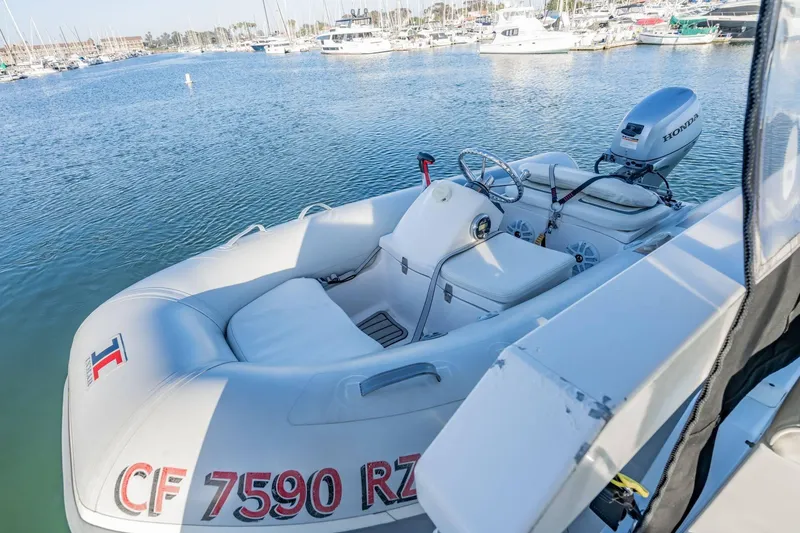 Slide: The Image of Inflatable boat with Honda motor docked near Carver 450 Voyager Pilothouse, 2000 model. - 78