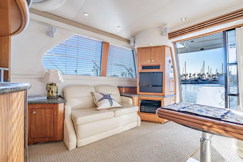 Slide: The Image of Luxurious interior of 2000 Carver 450 Voyager Pilothouse yacht with marina view. - 36