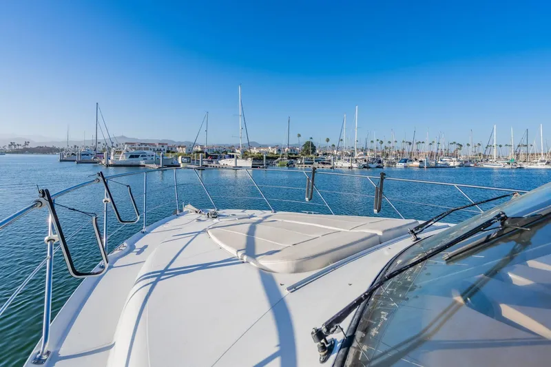 Slide: The Image of Carver 450 Voyager Pilothouse 2000 yacht docked in a marina under clear blue skies. - 22