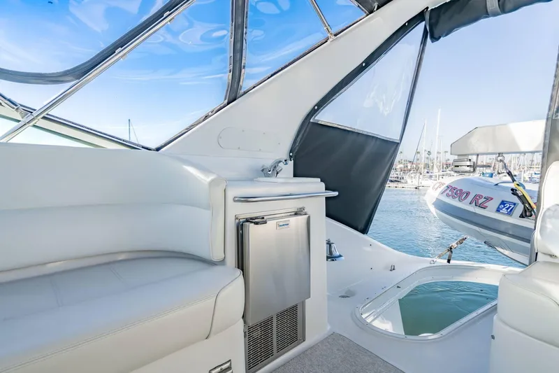 Slide: The Image of Interior view of 2000 Carver 450 Voyager Pilothouse yacht with seating and mini fridge. - 24
