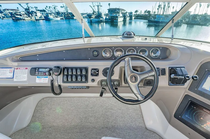 Slide: The Image of Pilothouse of 2000 Carver 450 Voyager with steering wheel and control panel. - 27