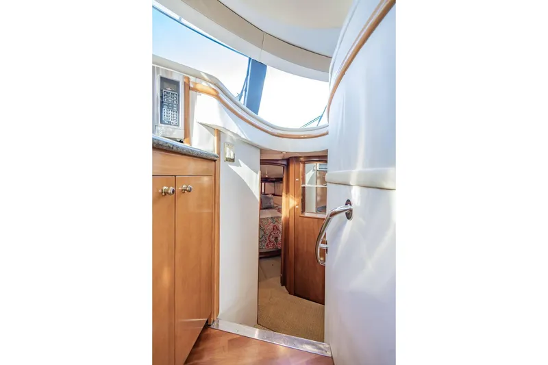 Slide: The Image of Interior view of 2000 Carver 450 Voyager Pilothouse, featuring wood cabinetry and cozy cabin entrance. - 49