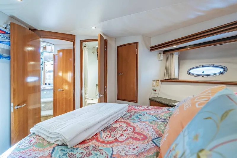 Slide: The Image of Luxurious bedroom interior of 2000 Carver 450 Voyager Pilothouse yacht with ensuite bathroom. - 56