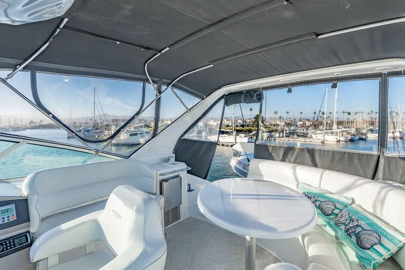 Slide: The Image of Luxurious interior of 2000 Carver 450 Voyager Pilothouse yacht with marina view. - 30