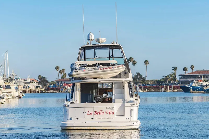 Slide: The Image of 2000 Carver 450 Voyager Pilothouse yacht named "La Bella Vita" in a marina setting. - 4
