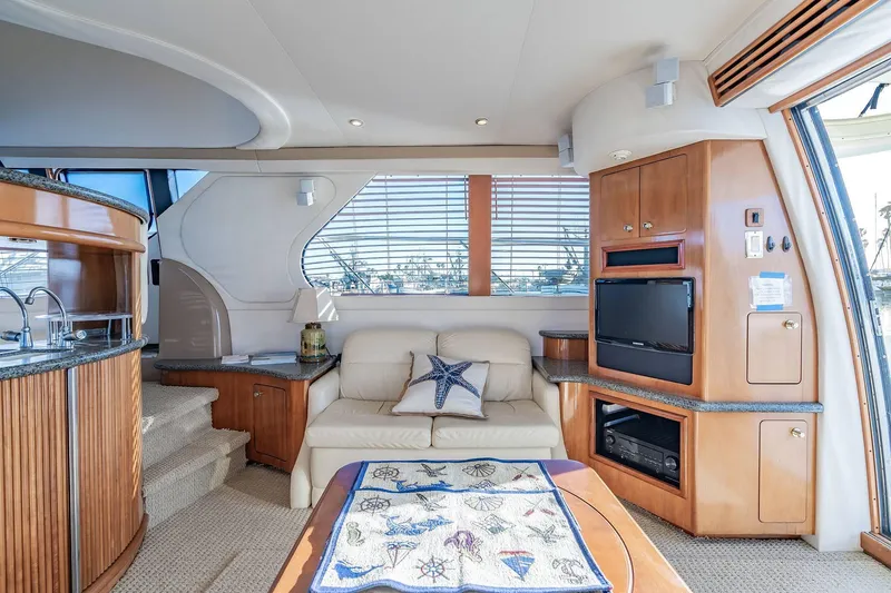 Slide: The Image of Luxurious interior of 2000 Carver 450 Voyager Pilothouse with sofa, TV, and kitchenette. - 34