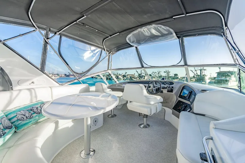 Slide: The Image of Luxurious interior of 2000 Carver 450 Voyager Pilothouse yacht with panoramic windows and plush seating. - 25