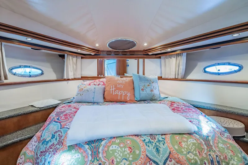 Slide: The Image of Luxurious bedroom interior of 2000 Carver 450 Voyager Pilothouse yacht with colorful bedding. - 54