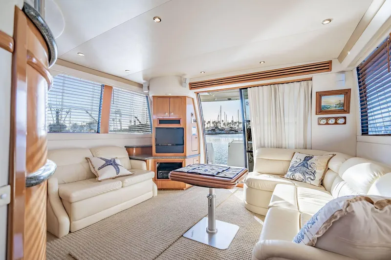 Slide: The Image of Luxurious interior of 2000 Carver 450 Voyager Pilothouse yacht with plush seating and scenic views. - 38
