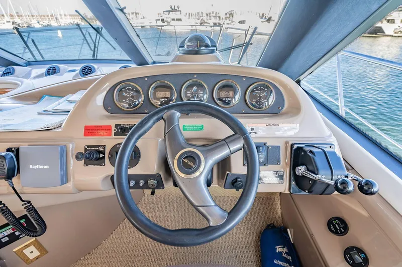 Slide: The Image of Pilothouse of 2000 Carver 450 Voyager with steering wheel and control panel, docked at marina. - 45