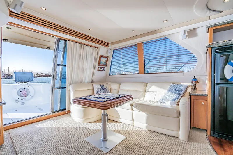 Slide: The Image of Luxurious interior of 2000 Carver 450 Voyager Pilothouse yacht with elegant seating and scenic view. - 33