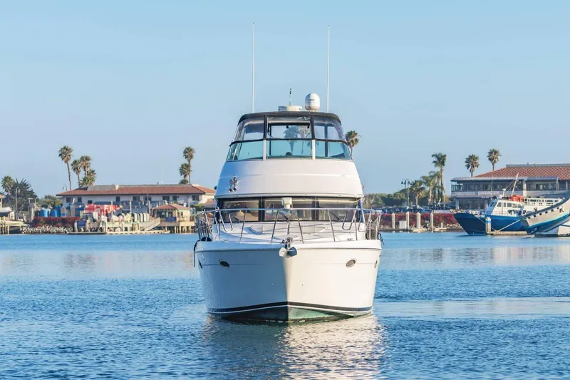 Slide: The Image of Front view of a 2000 Carver 450 Voyager Pilothouse yacht on calm water. - 10