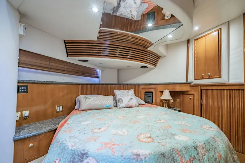 Slide: The Image of Luxurious bedroom interior of 2000 Carver 450 Voyager Pilothouse yacht with nautical-themed bedding. - 61