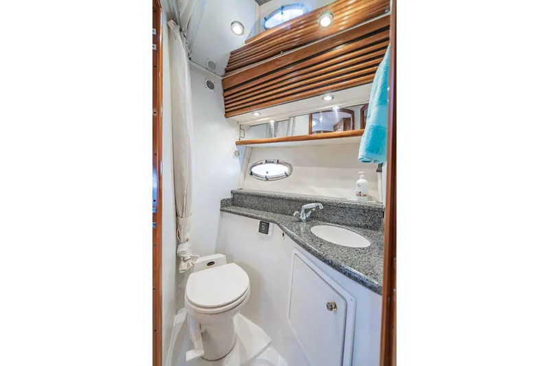Slide: The Image of Bathroom interior of 2000 Carver 450 Voyager Pilothouse with granite countertop and porthole window. - 59