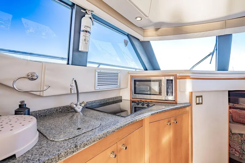 Slide: The Image of Interior of 2000 Carver 450 Voyager Pilothouse with modern kitchen amenities. - 41