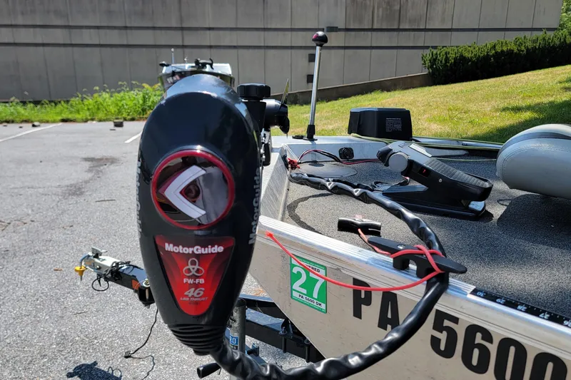 Slide: The Image of 2013 Lowe Skorpion boat with MotorGuide trolling motor in a parking lot. - 2