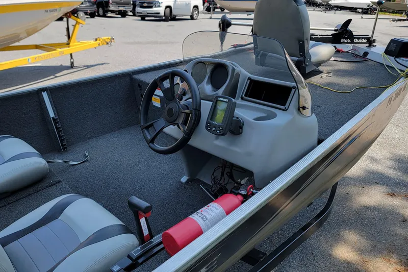 Slide: The Image of 2013 Lowe Skorpion boat interior with steering wheel, seats, and navigation equipment. - 7