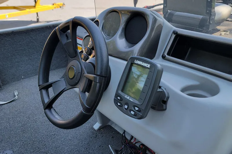 Slide: The Image of Steering wheel and Lowrance X-4 Pro fishfinder on 2013 Lowe Skorpion boat dashboard. - 8