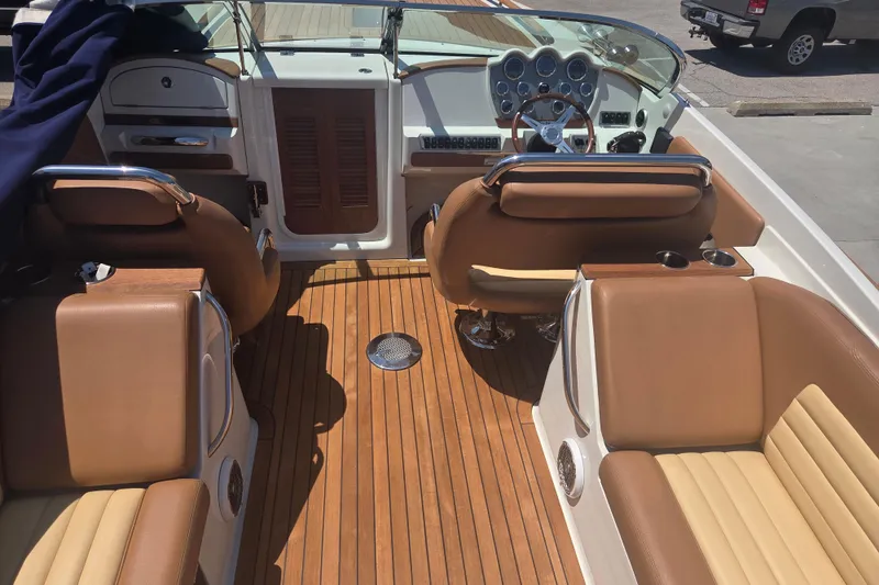 Slide: The Image of Interior of a 2013 Chris-Craft Corsair 28 boat with luxurious seating and wooden flooring. - 4