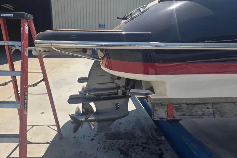 Slide: The Image of 2013 Chris-Craft Corsair 28 boat on a trailer, showing stern and propeller. - 24