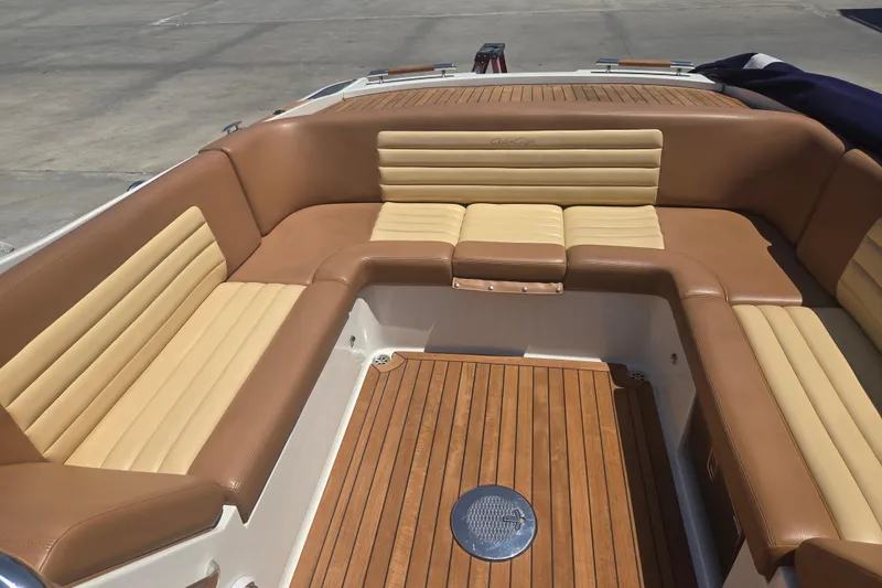 Slide: The Image of Luxurious 2013 Chris-Craft Corsair 28 boat interior with tan leather seating and wooden flooring. - 6
