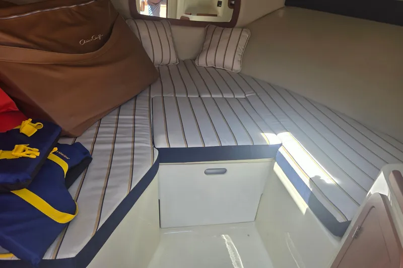 Slide: The Image of Interior cabin of 2013 Chris-Craft Corsair 28 with striped cushions and life jackets. - 14