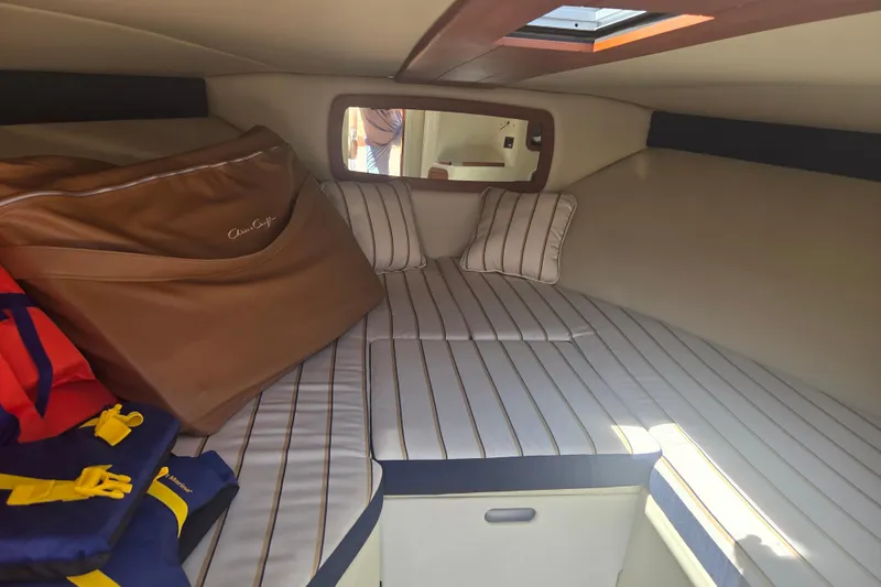 Slide: The Image of Cozy cabin interior of 2013 Chris-Craft Corsair 28 with striped cushions and storage. - 12