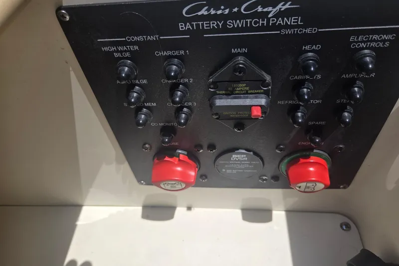 Slide: The Image of 2013 Chris-Craft Corsair 28 battery switch panel with various controls and switches. - 21