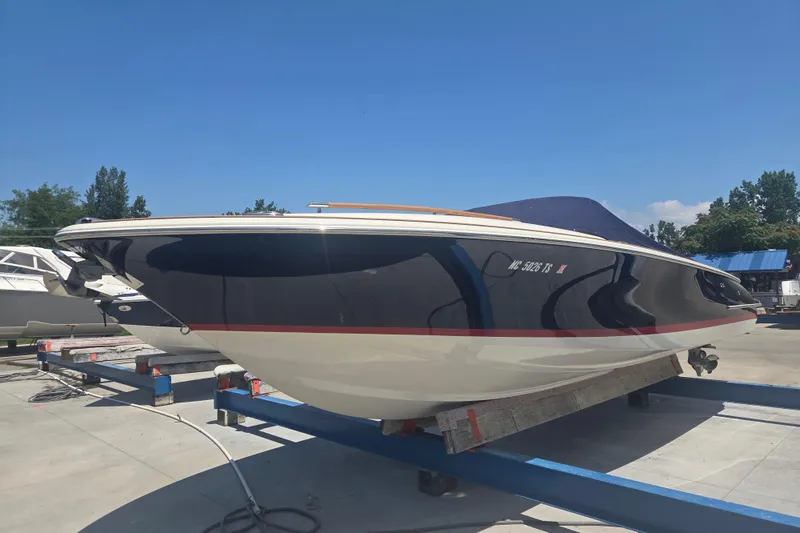 Slide: The Image of 2013 Chris-Craft Corsair 28 boat on trailer under clear blue sky. - 2