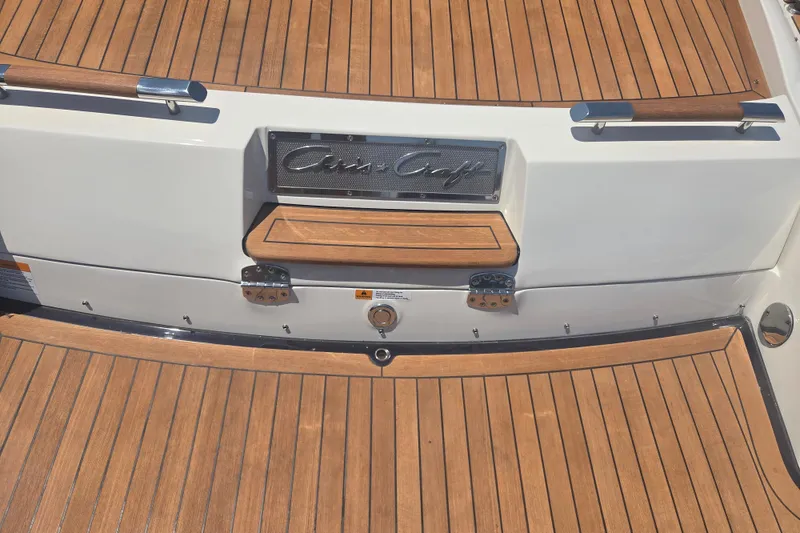 Slide: The Image of 2013 Chris-Craft Corsair 28 boat with teak deck and branded emblem. - 19