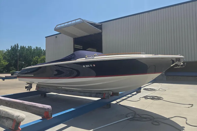 Slide: The Image of 2013 Chris-Craft Corsair 28 boat on trailer outside storage facility. - 17